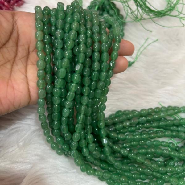 Dul Dul Beads pista Green colour   5 X 7mm approx